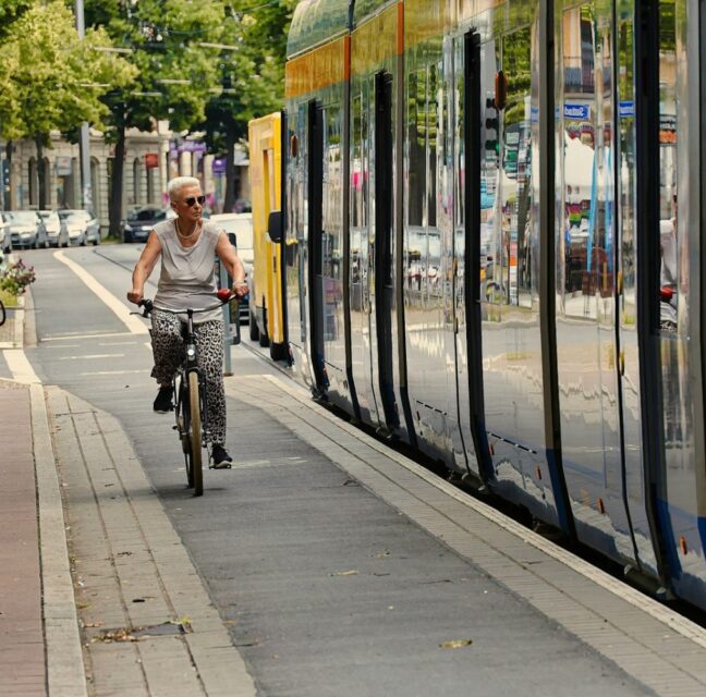 An older rider looking out the window of a community bus