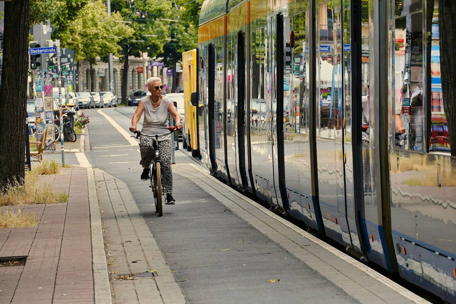 An older rider looking out the window of a community bus